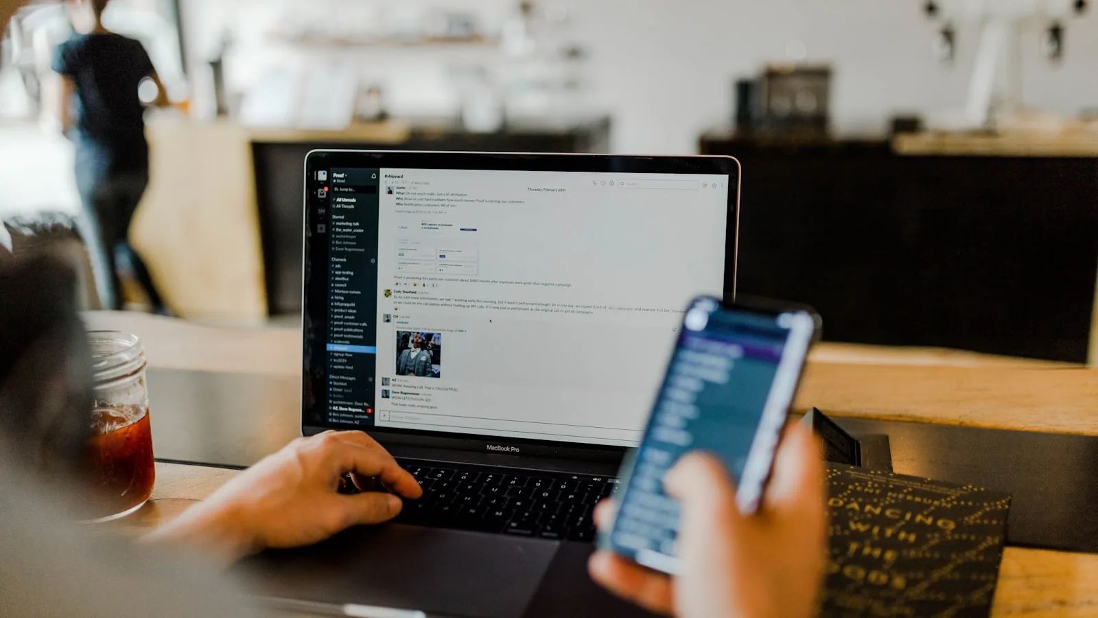 Person using a laptop and a smartphone